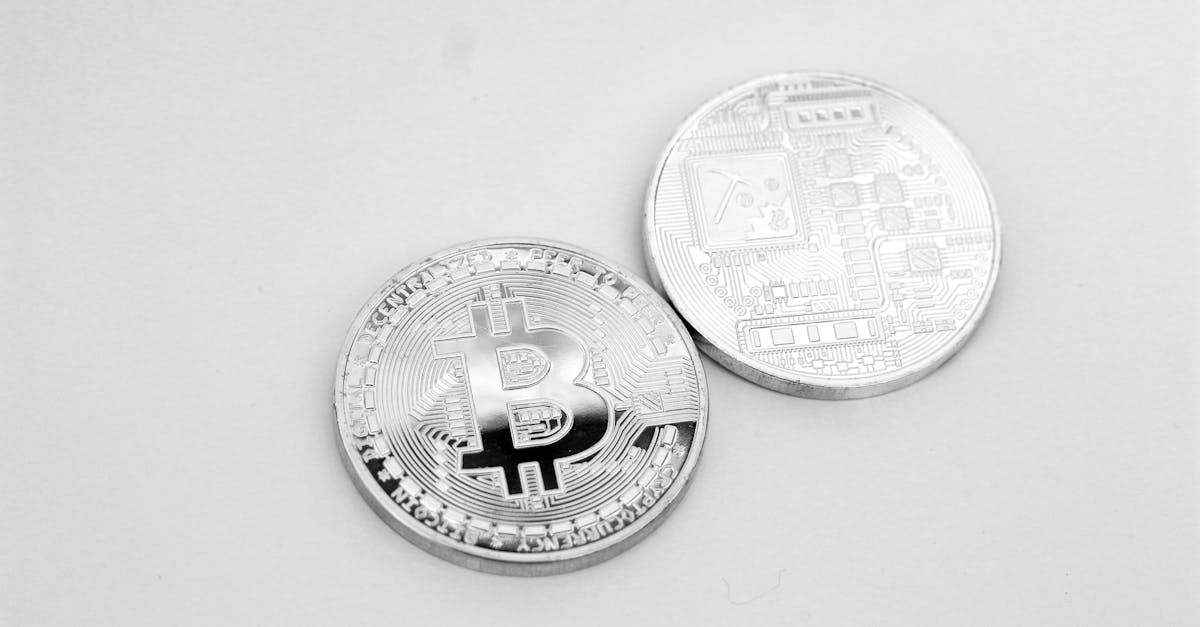 Close-up of two silver Bitcoin coins showcasing digital currency and modern finance.
